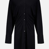 The TOTEME Slouch Jersey Shirt Dress features a relaxed fit, classic collar, front buttons, and long sleeves. Crafted from featherlight fabric and inspired by classic silhouettes, it's shown against a plain white background.