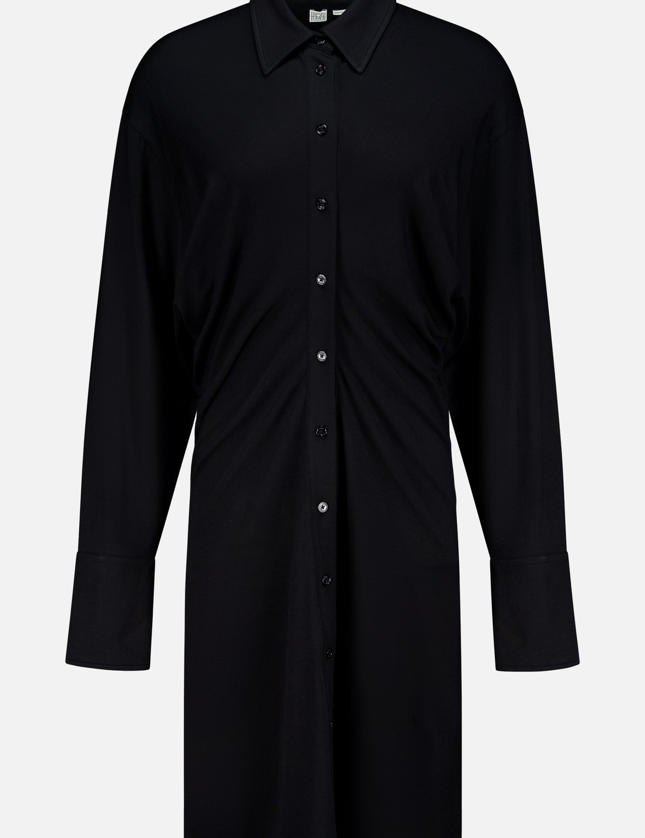 The TOTEME Slouch Jersey Shirt Dress features a relaxed fit, classic collar, front buttons, and long sleeves. Crafted from featherlight fabric and inspired by classic silhouettes, it's shown against a plain white background.