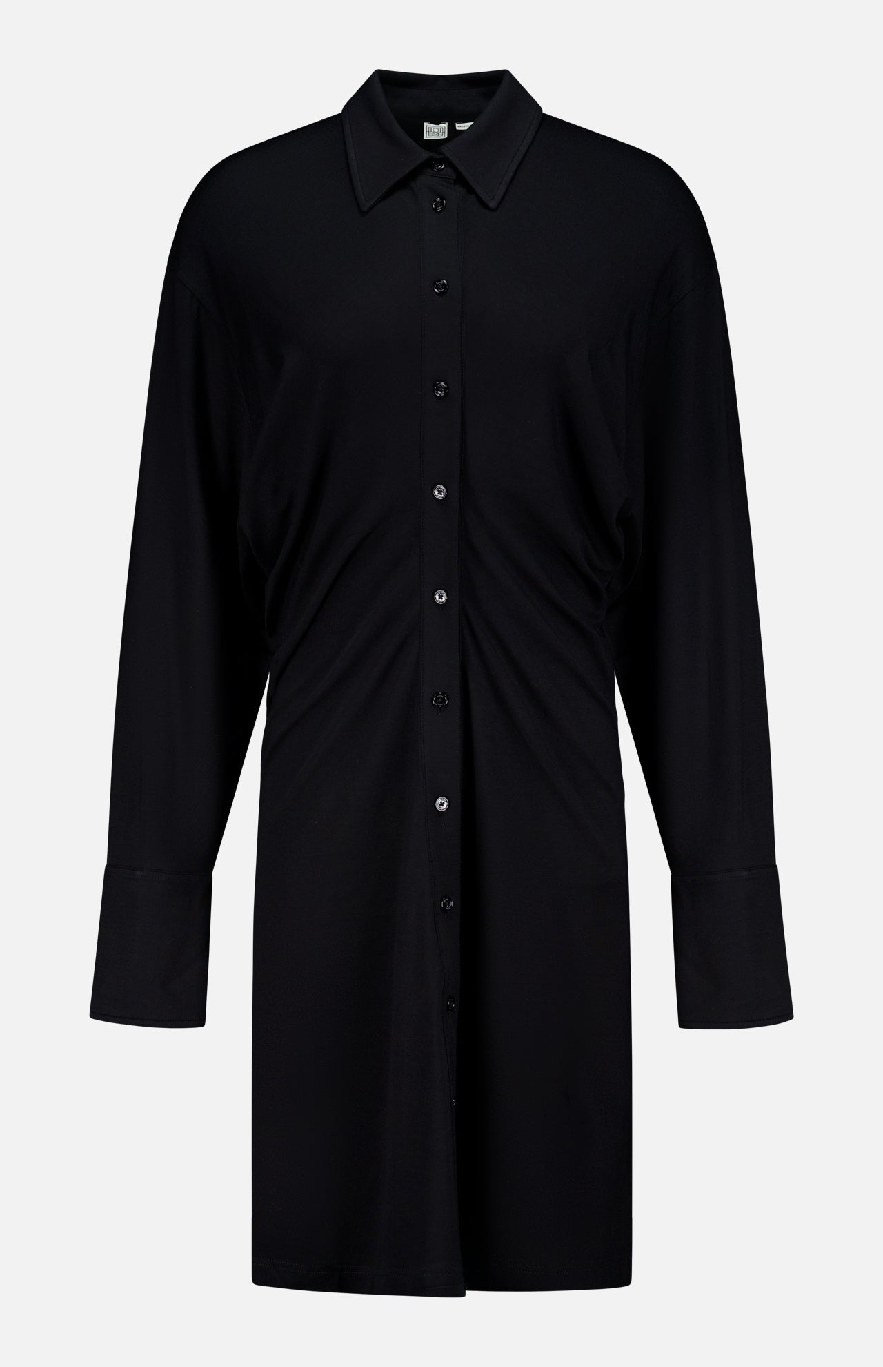 The TOTEME Slouch Jersey Shirt Dress features a relaxed fit, classic collar, front buttons, and long sleeves. Crafted from featherlight fabric and inspired by classic silhouettes, it's shown against a plain white background.