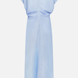 The Slouch Waist Dress by TOTEME is displayed from the back in pale blue, with a textured fabric, short sleeves, high neckline, and relaxed cinched waist. Curved panels enhance the design to a floor-length hem.