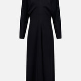 The TOTEME Slouch Waist Scarf Dress is a black, long-sleeved, knee-length dress featuring voluminous sleeves, a fitted waist, and a central seam detail, shown against a plain white background.