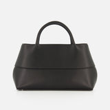 A Small Mercer Leather Tote Bag by TOTEME sits on a white background. Crafted in Italy, this black tote features two short handles, a minimalist design, and a smooth, matte finish.