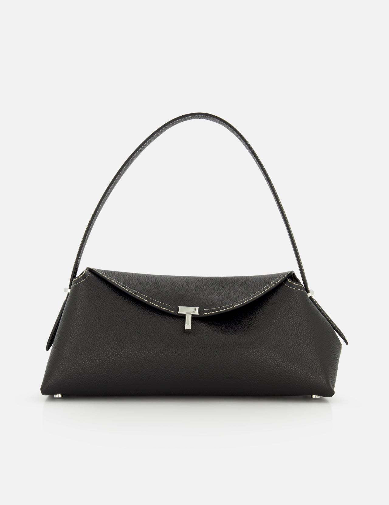 The TOTEME T-Lock Grained Leather Shoulder Bag, made in Italy from black pebble-grained leather, features a single curved strap, silver-tone hardware, and a front flap closure. Shown against a plain white background.