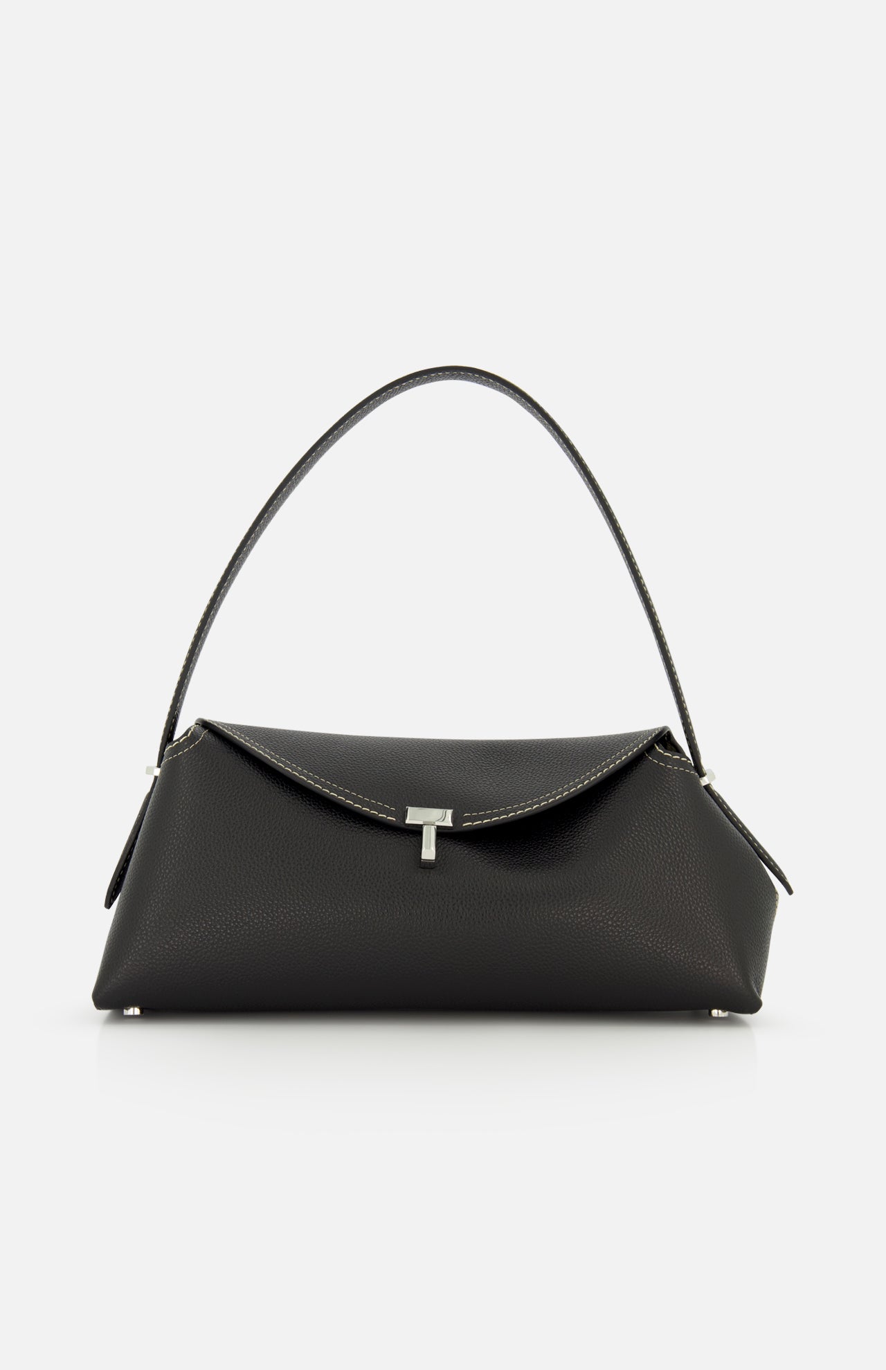The TOTEME T-Lock Grained Leather Shoulder Bag, made in Italy from black pebble-grained leather, features a single curved strap, silver-tone hardware, and a front flap closure. Shown against a plain white background.
