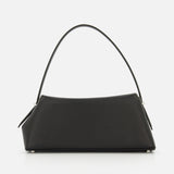 The TOTEME T-Lock Grained Leather Shoulder Bag features a sculptural, rectangular silhouette in black pebble-grained leather with a single curved handle, minimal silver hardware, and is shown against a white background.