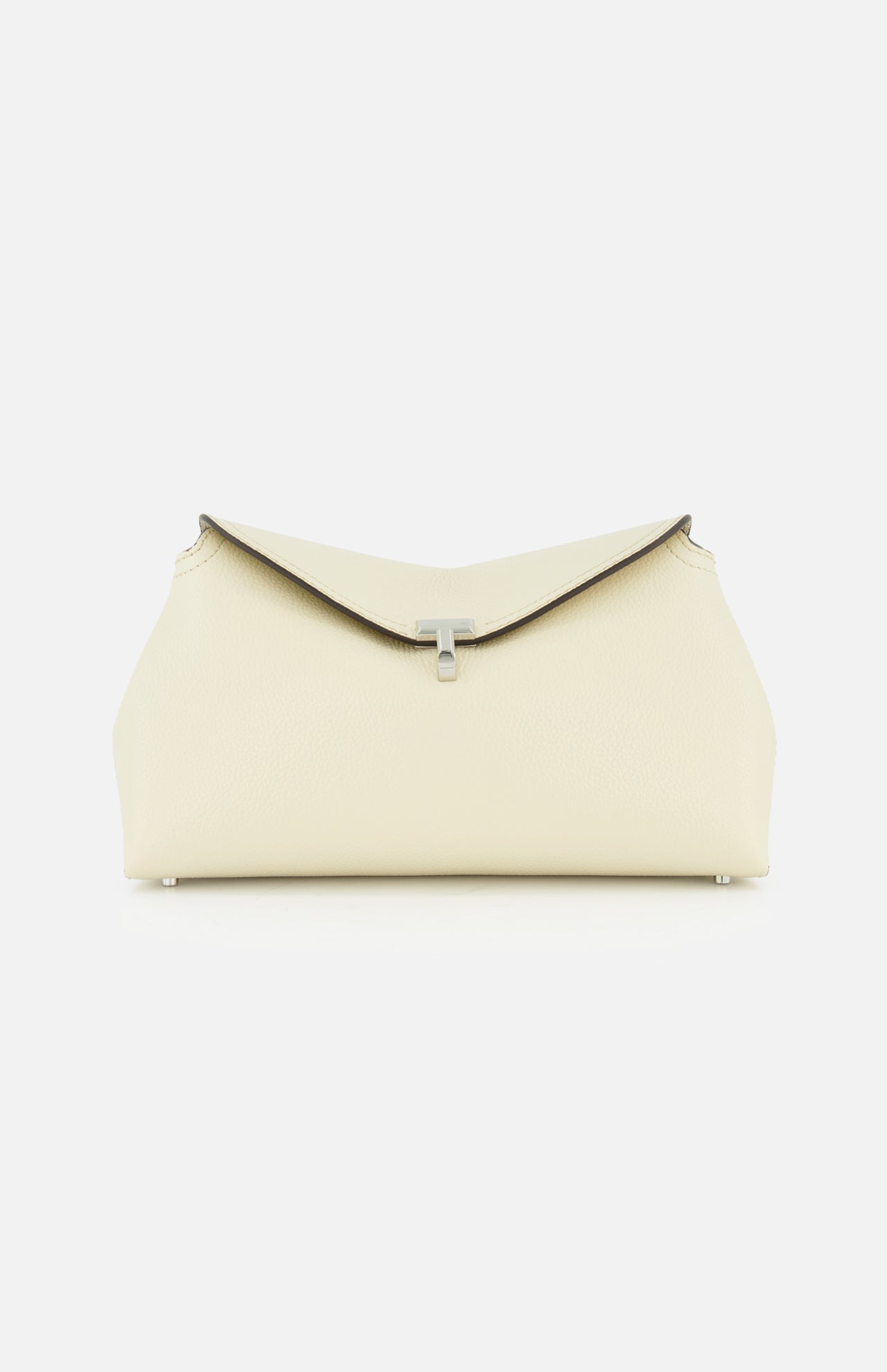The TOTEME T-Lock Grained-Leather Clutch Bag is a cream Italian leather clutch with a flap closure and sleek silver clasp, shown against a plain white background.