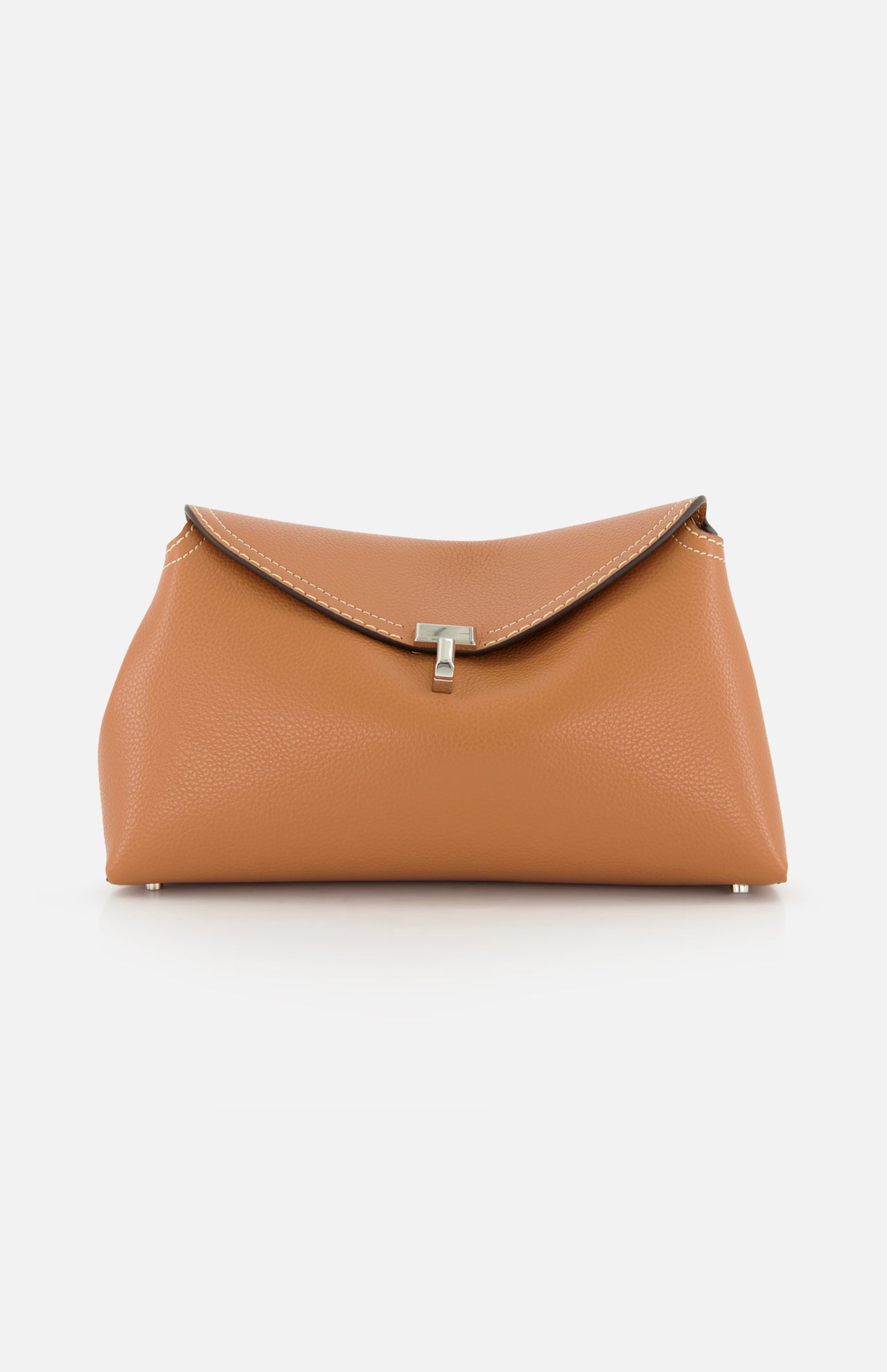 The TOTEME T-Lock Grained-Leather Clutch is an Italian-made tan leather bag featuring a flap closure, white stitching, and a central silver clasp, shown against a plain white background.