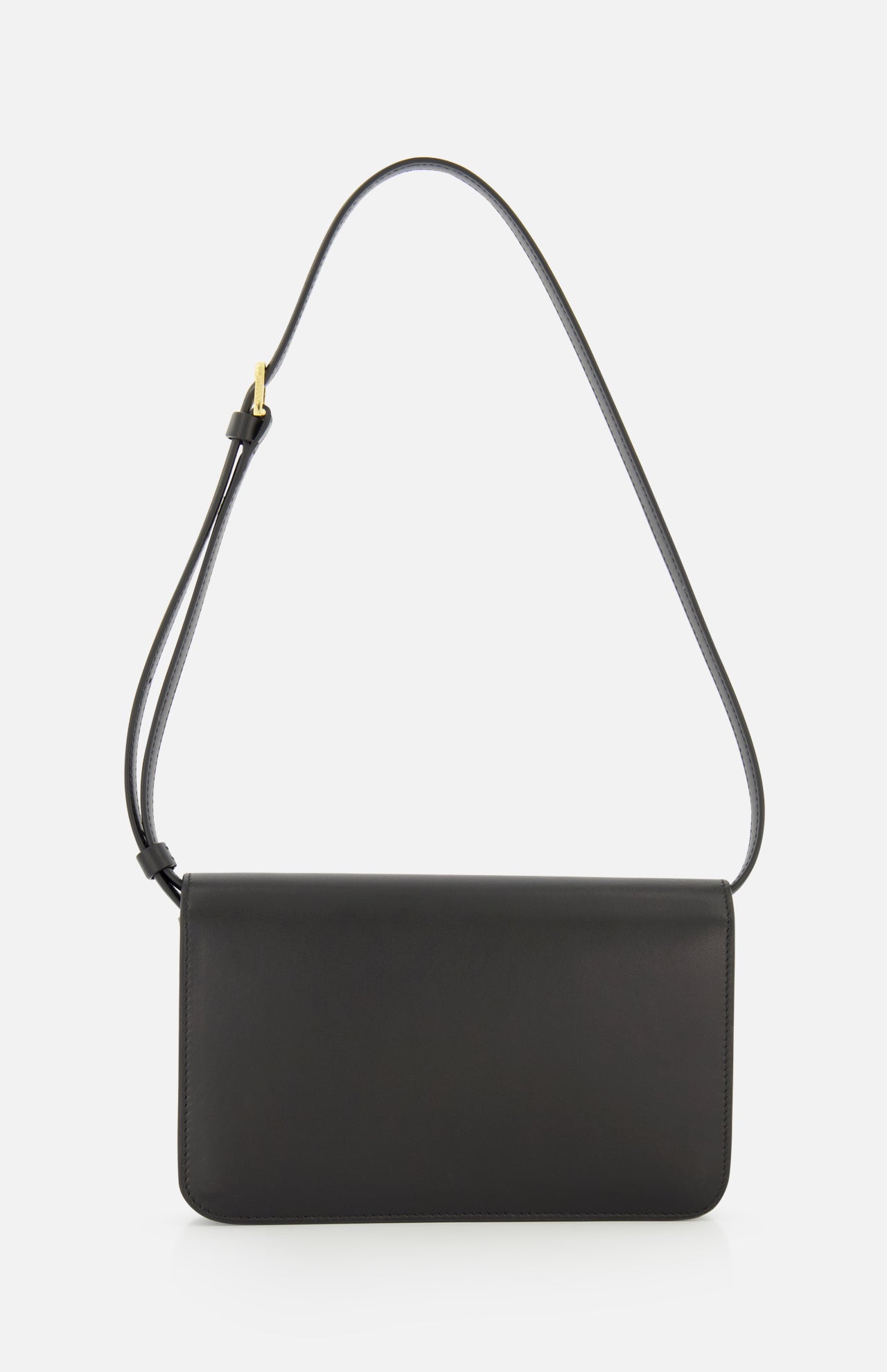 The TOTEME T-Lock Leather Crossbody Bag is a sculptural shoulder bag crafted from black leather, featuring a rectangular shape, slim profile, and an adjustable strap, beautifully displayed against a plain white background.