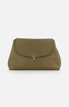 The TOTEME T-Lock Leather Satchel Bag is a large olive green leather bag with a curved flap, small silver center clasp, smooth minimalist design, and adjustable strap, shown against a plain white background.