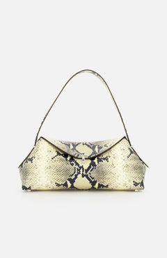 The TOTEME T-Lock Python Embossed Shoulder Bag features a structured rectangular silhouette in beige and black python-effect leather, designed with a short handle and a flap closure, and is shown against a plain white background.