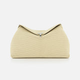 The TOTEME T-Lock Rope Clutch is a beige, sculptural bag with a textured finish and structured, rounded shape, accented by a small silver clasp on top. Photographed on a white background, it showcases timeless elegance.
