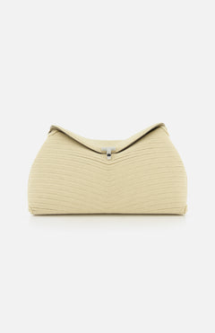 The TOTEME T-Lock Rope Clutch is a beige, sculptural bag with a textured finish and structured, rounded shape, accented by a small silver clasp on top. Photographed on a white background, it showcases timeless elegance.