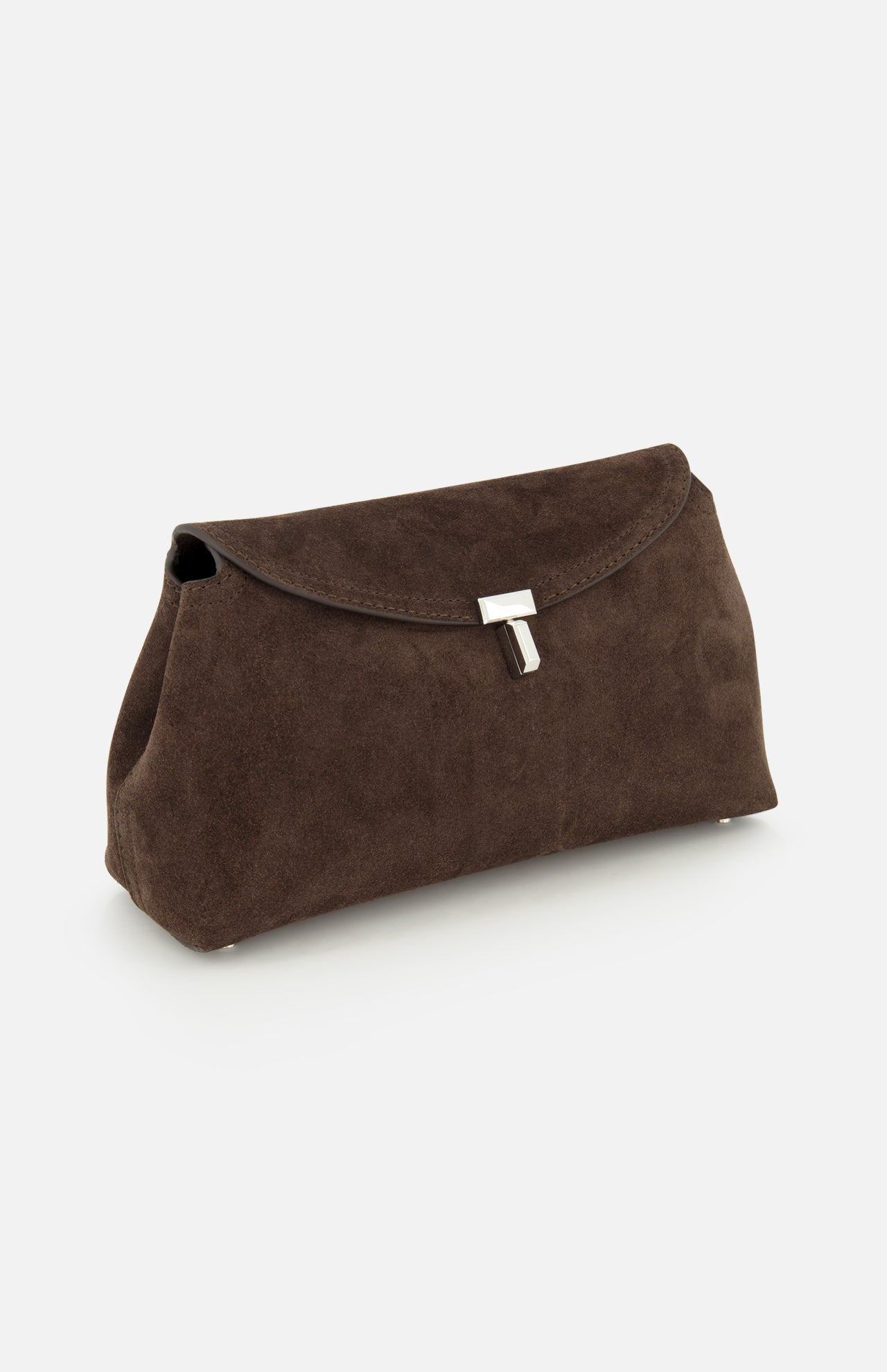 The TOTEME T-Lock Suede Clutch, a chocolate brown sculptural bag with a silver clasp crafted in Italy, stands upright on a white background.
