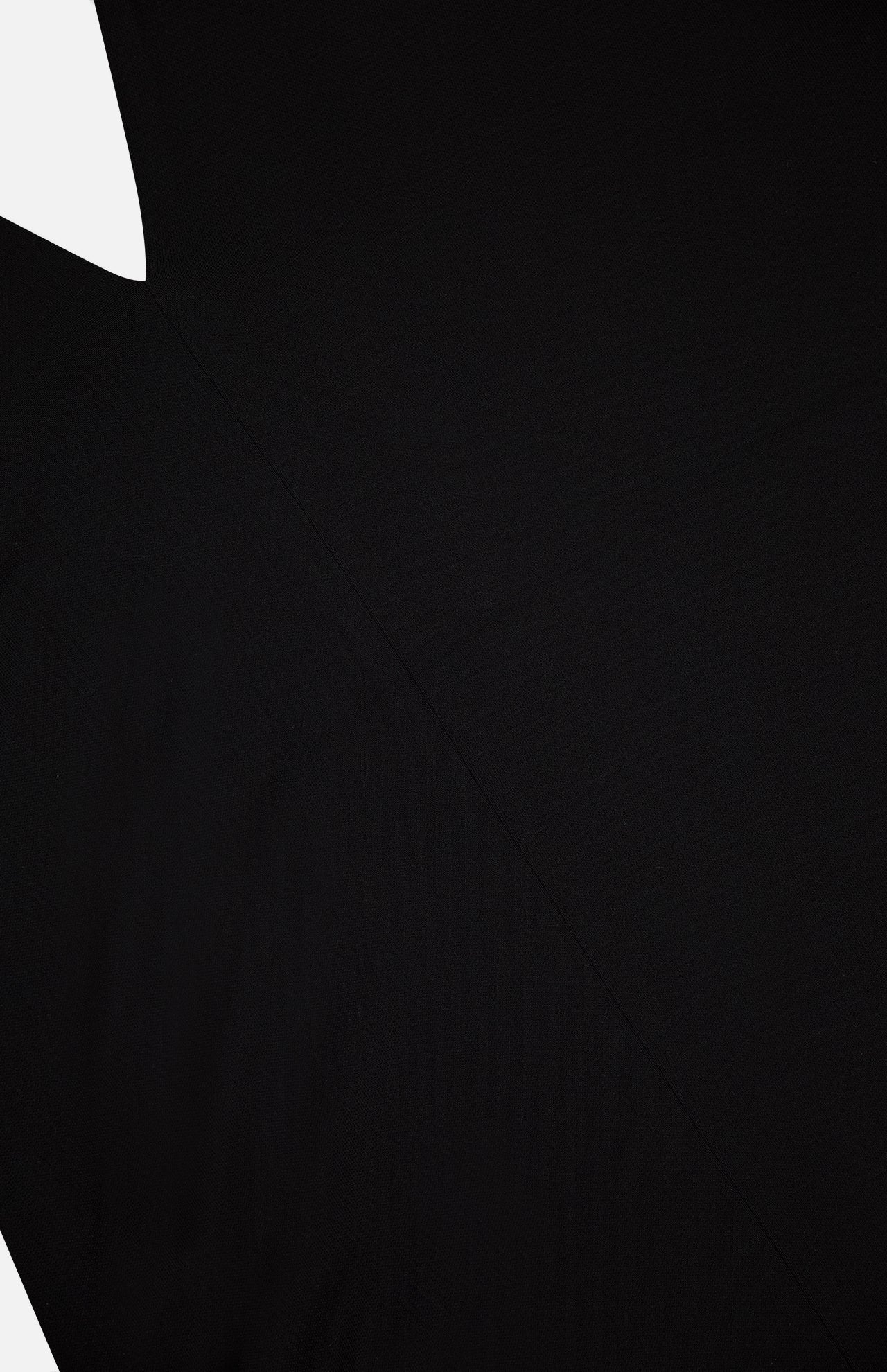 A close-up of TOTEME's Twisted Jersey Halter Top shows its plain black fabric with subtle diagonal seam lines, highlighting the minimalistic and monochrome design.