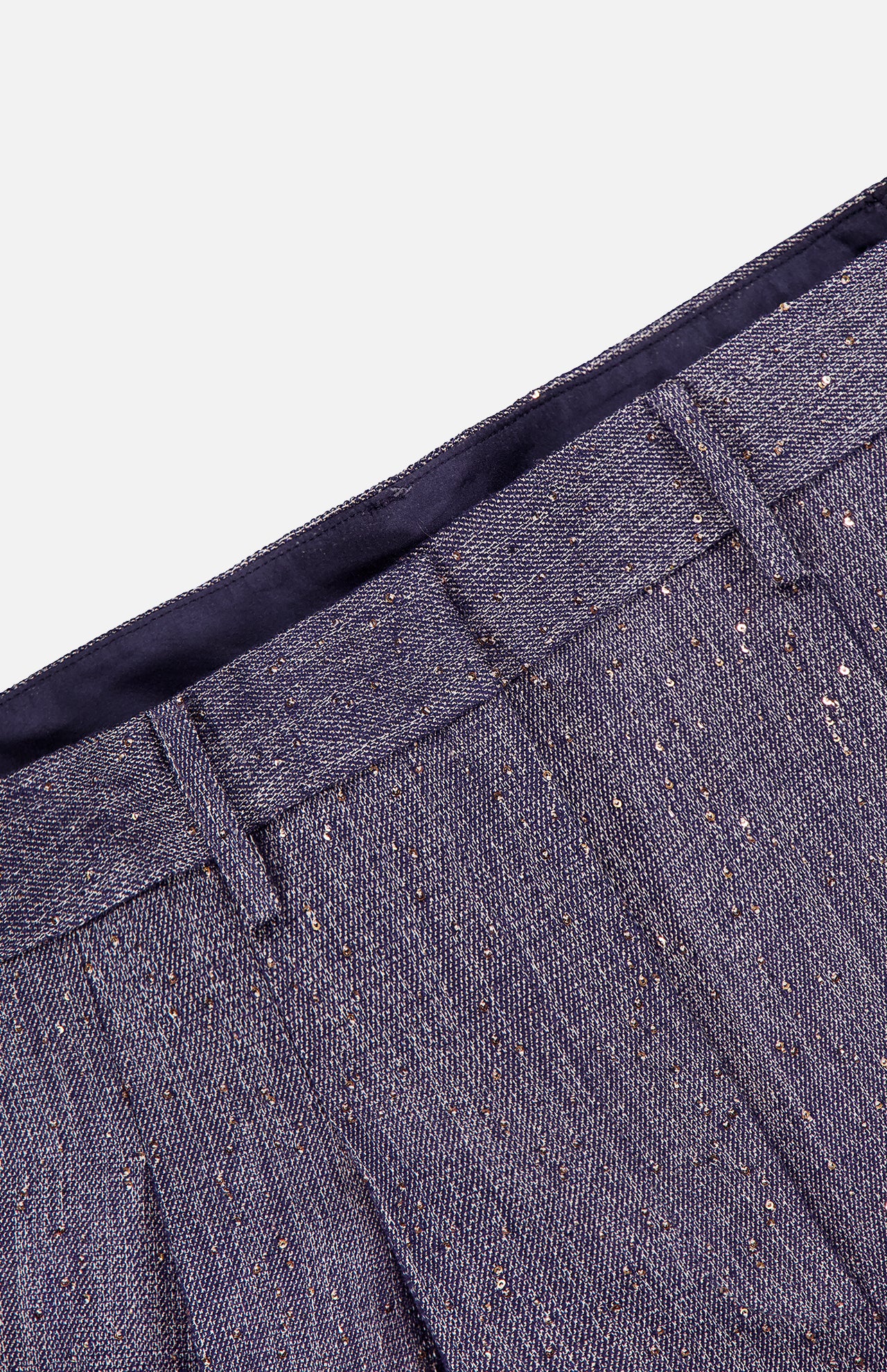 Close-up of the TWP Avery Sequin Denim Trouser Pant, featuring sparkly purple sequins, visible belt loops, a fitted waistband, and textured fabric with fine metallic specks.
