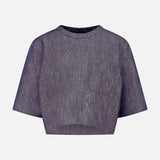 The TWP Ex Cropped Sequin Denim T Shirt features a short-sleeved, boxy silhouette in shimmery dark gray with a round neckline and small chest pocket, shown against a plain light background.