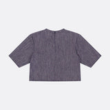 A back view of the TWP Ex Cropped Sequin Denim T Shirt, a short-sleeved, dark gray textured top with a straight hem, subtle speckled pattern, and boxy cropped silhouette, shown against a plain light background.