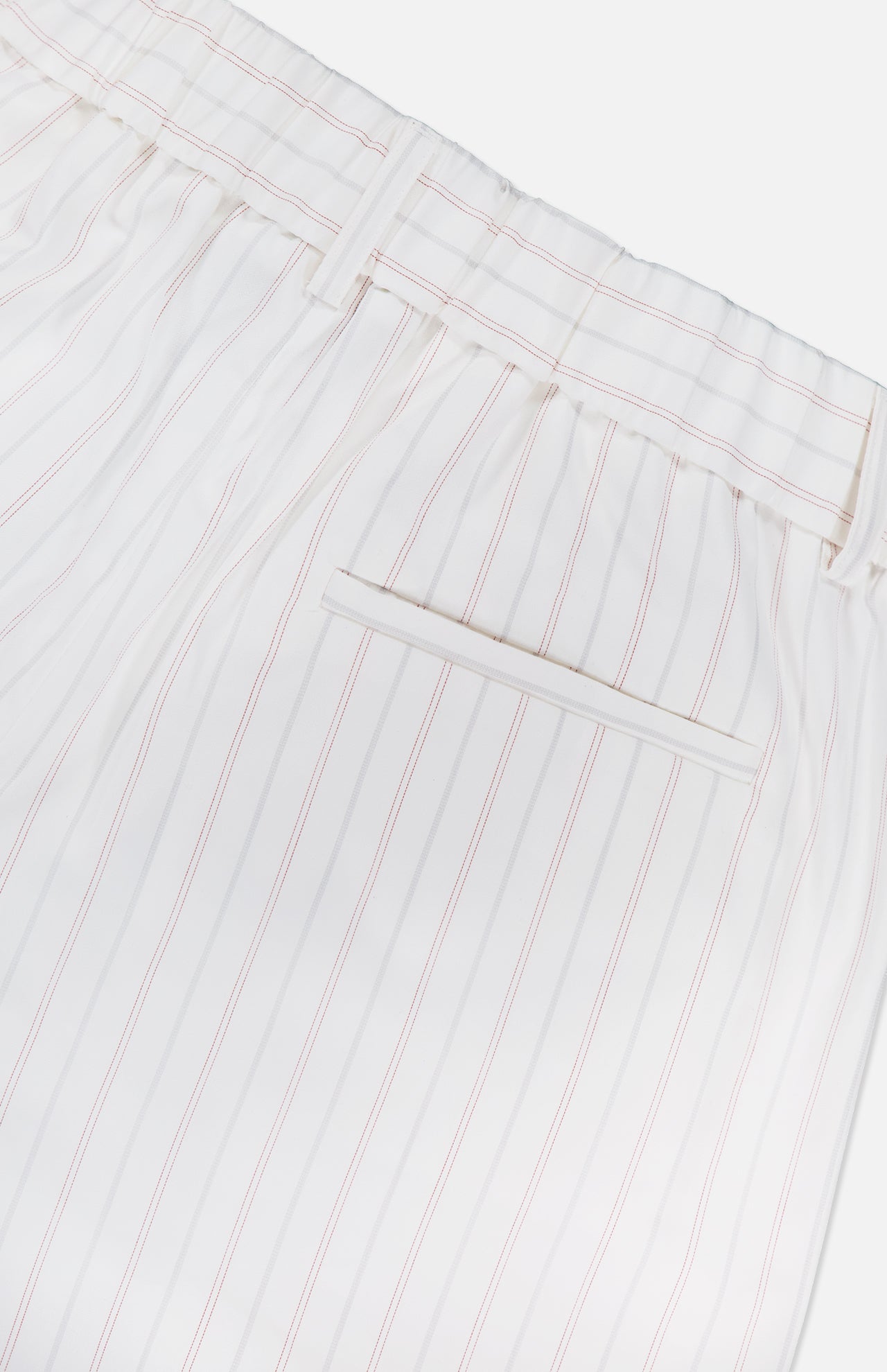 The Hudson St Trouser Pant by TWP features thin vertical red stripes on white, an elasticized waist, belt loops, and a single welt back pocket for a relaxed look.