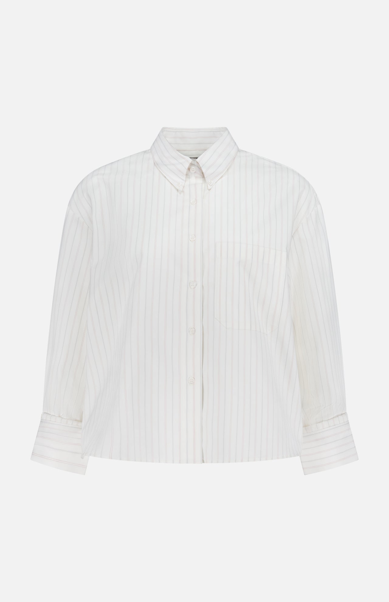 The TWP J.D. Shirt is a women’s white, long-sleeve top with thin vertical pastel stripes, a single chest pocket, and a pointed collar, shown on a plain white background.