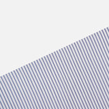 The Striped A-Line Skirt from TWP features diagonal blue and white pinstripes for a clean, minimal look—perfect for women’s workwear or classic style.
