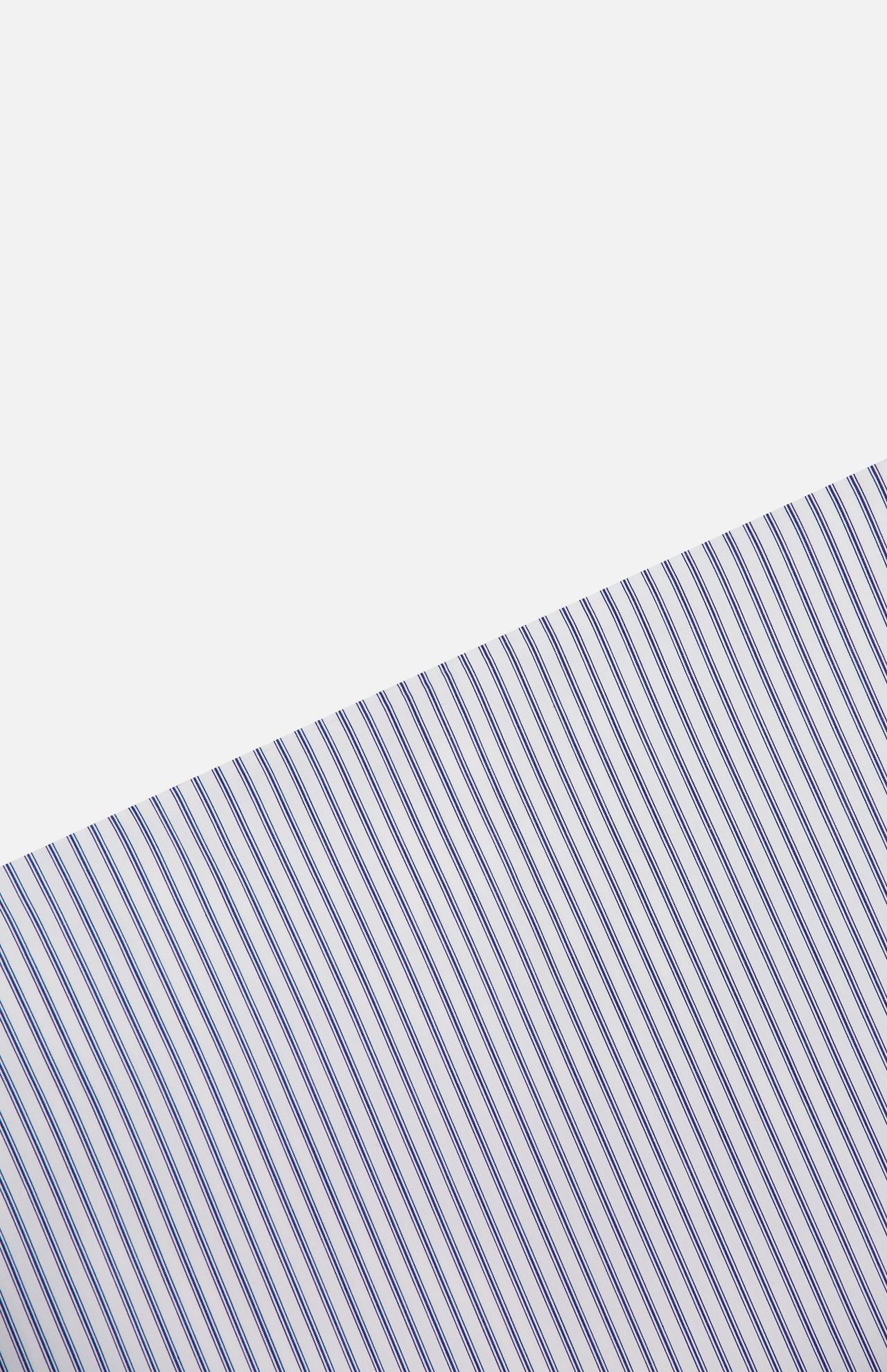 The Striped A-Line Skirt from TWP features diagonal blue and white pinstripes for a clean, minimal look—perfect for women’s workwear or classic style.