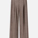 The Avery Wide Leg Trouser Pant by TWP showcases a refined, wide-leg silhouette with a high-waisted fit, front pleats, and belt loops in a rich brown hue—an ideal and versatile workwear option for women. Displayed on a plain white background.