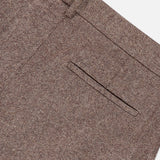 Close-up of the TWP Avery Wide Leg Trouser Pant in a brown herringbone pattern, featuring a waistband with belt loops and a single welt pocket detail on a white background—an elevated take on women’s workwear.