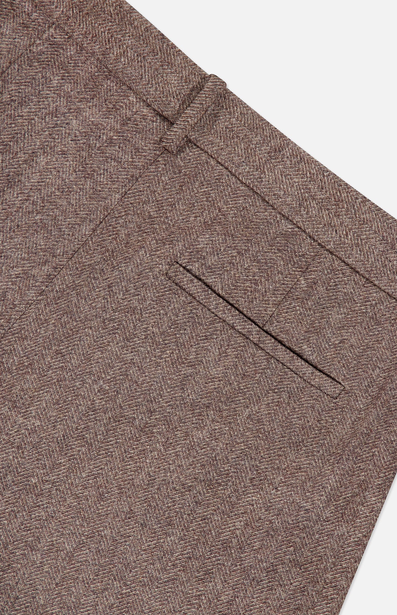 Close-up of the TWP Avery Wide Leg Trouser Pant in a brown herringbone pattern, featuring a waistband with belt loops and a single welt pocket detail on a white background—an elevated take on women’s workwear.