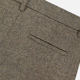 Close-up of the TWP Avery Herringbone Wide Leg Trouser in brown cashmere wool, highlighting the herringbone pattern, waistband with belt loops, and a neatly finished back pocket without visible buttons.