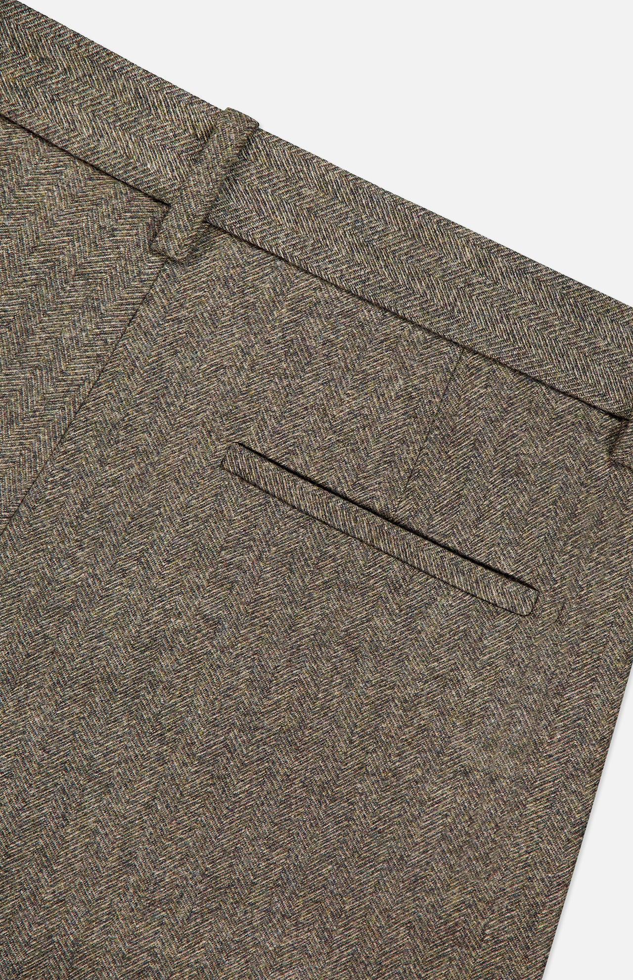 Close-up of the TWP Avery Herringbone Wide Leg Trouser in brown cashmere wool, highlighting the herringbone pattern, waistband with belt loops, and a neatly finished back pocket without visible buttons.