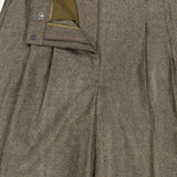 Close-up of the TWP Avery Herringbone Wide Leg Trouser in brown cashmere wool, featuring a waistband with belt loops, zipper fly, button closure, and olive green pocket lining—an elevated workwear option for women.