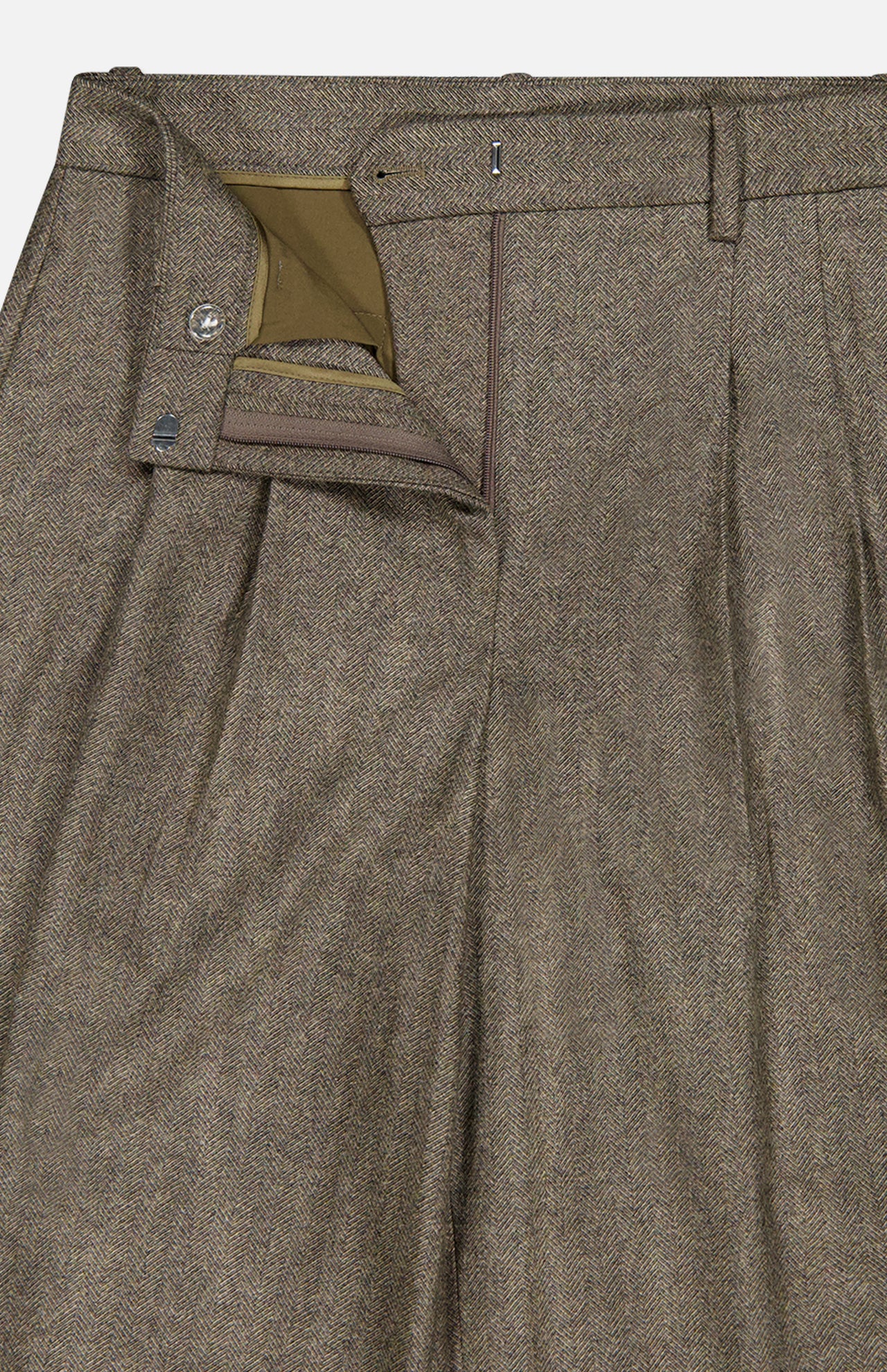 Close-up of the TWP Avery Herringbone Wide Leg Trouser in brown cashmere wool, featuring a waistband with belt loops, zipper fly, button closure, and olive green pocket lining—an elevated workwear option for women.