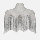 The TWP Beaded Silk Topper features a silver high neck, rhinestone embellishments, and chevron-patterned fringe on a plain white background.
