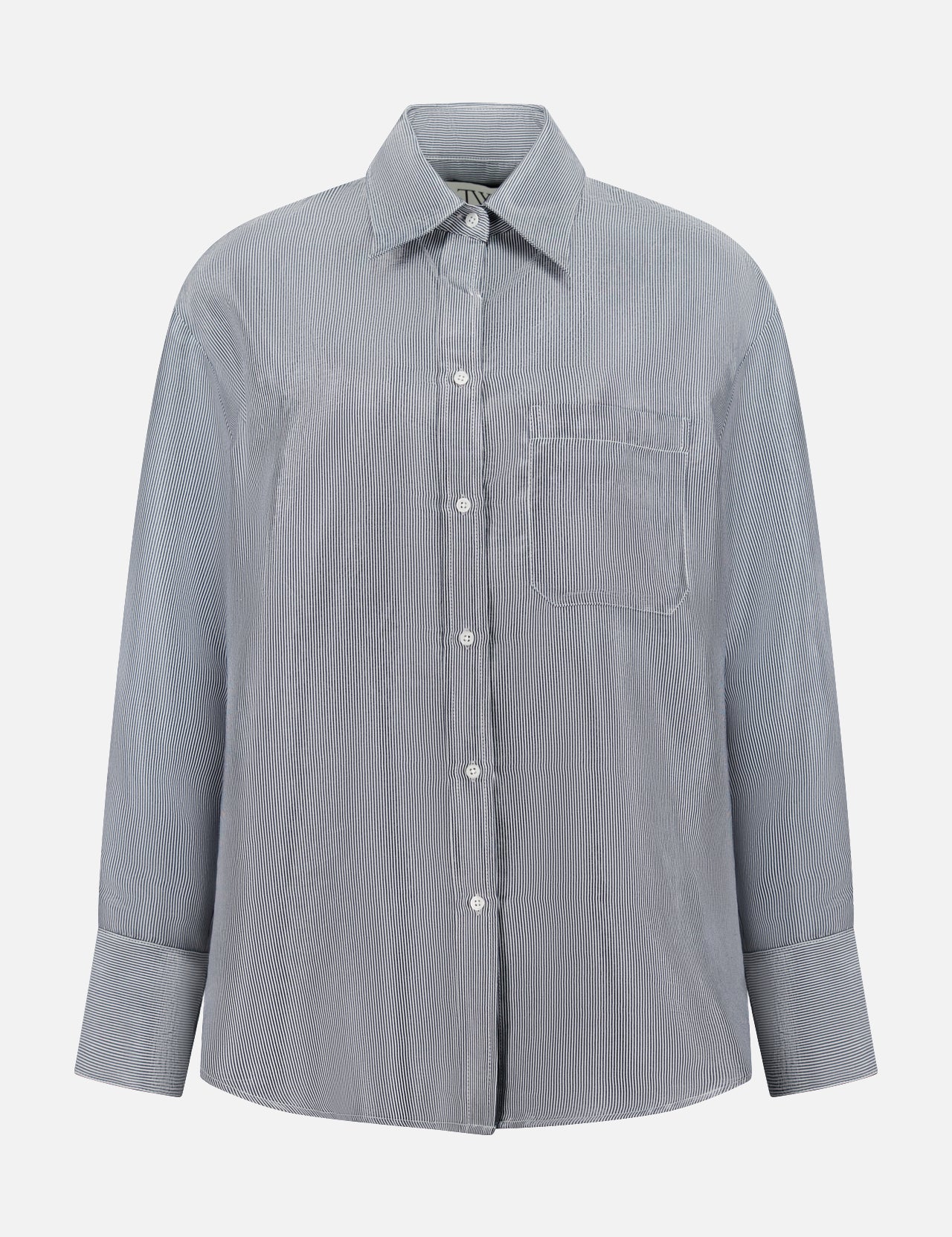 The TWP Big Joe Glossy Stripe Shirt is a women's oversized, long-sleeve button-up in light gray with subtle vertical stripes, a chest pocket, and classic collar—ideal for workwear and shown on a white background.