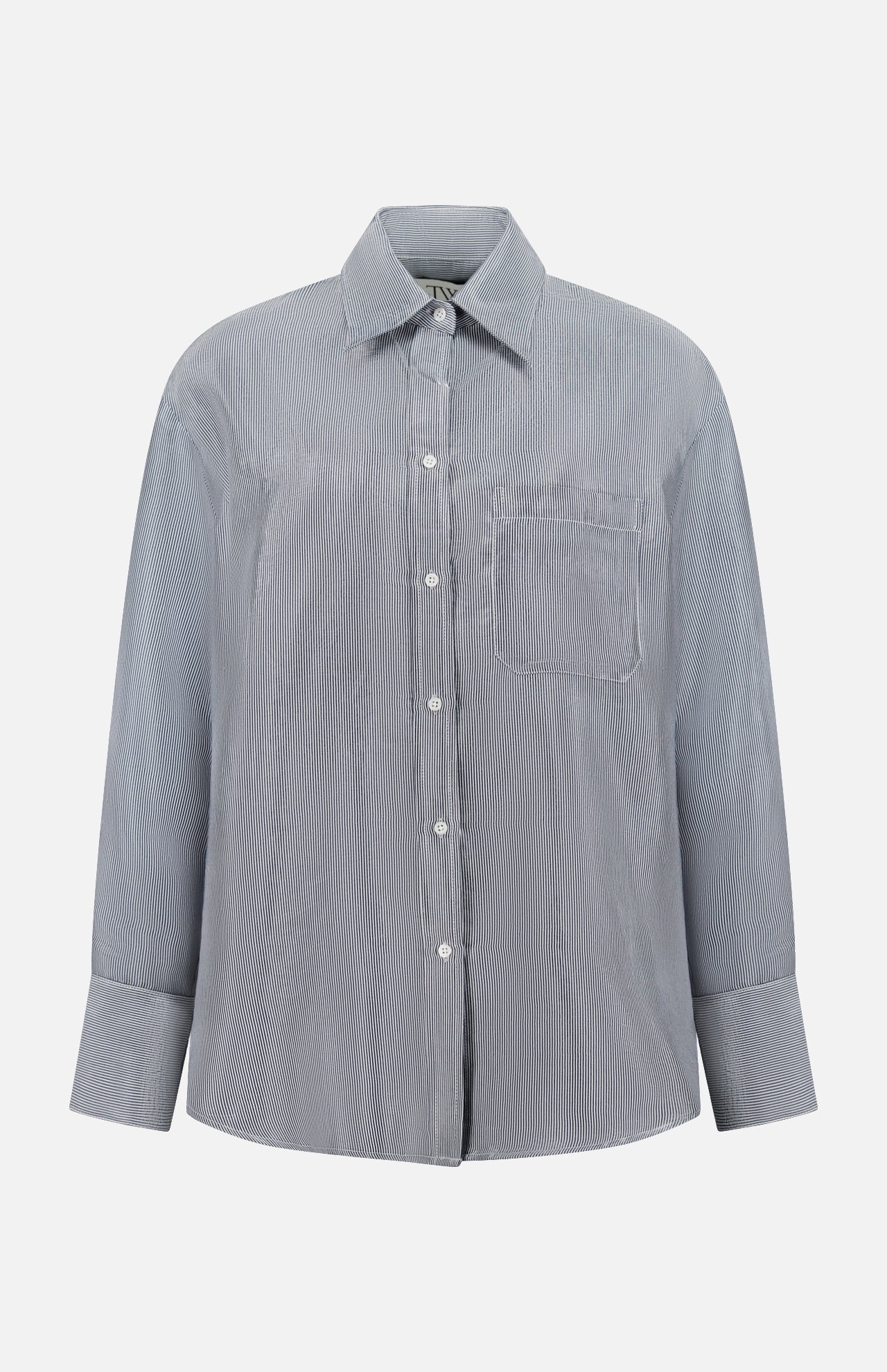 The TWP Big Joe Glossy Stripe Shirt is a women's oversized, long-sleeve button-up in light gray with subtle vertical stripes, a chest pocket, and classic collar—ideal for workwear and shown on a white background.