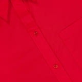 Close-up of the Big Joe Oversized Shirt Dress by TWP, featuring a bright red color, button-up front, collared neckline, chest pocket, and a white tag with "WP"—the perfect comfortable workwear option for women.