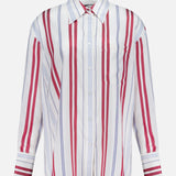 The Big Joe Oversized Shirt by TWP is a menswear-inspired, long-sleeve button-up with a collar, single chest pocket, and vertical red and blue stripes on a white background.