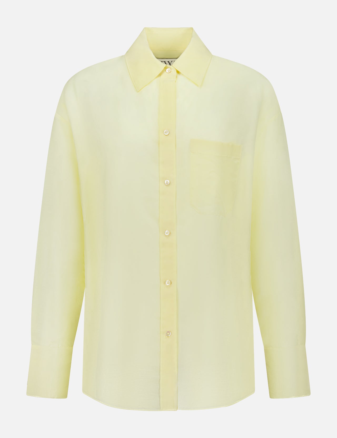 The TWP Big Joe Oversized Shirt is a light yellow, long-sleeved top made from a cotton silk blend, featuring a collar and chest pocket, shown against a plain white background.