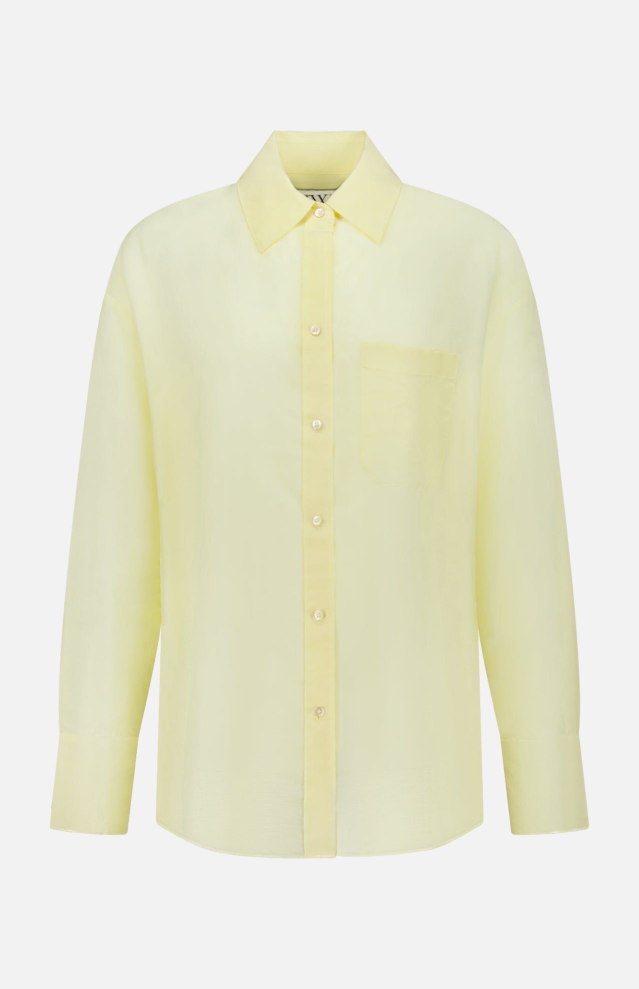The TWP Big Joe Oversized Shirt is a light yellow, long-sleeved top made from a cotton silk blend, featuring a collar and chest pocket, shown against a plain white background.