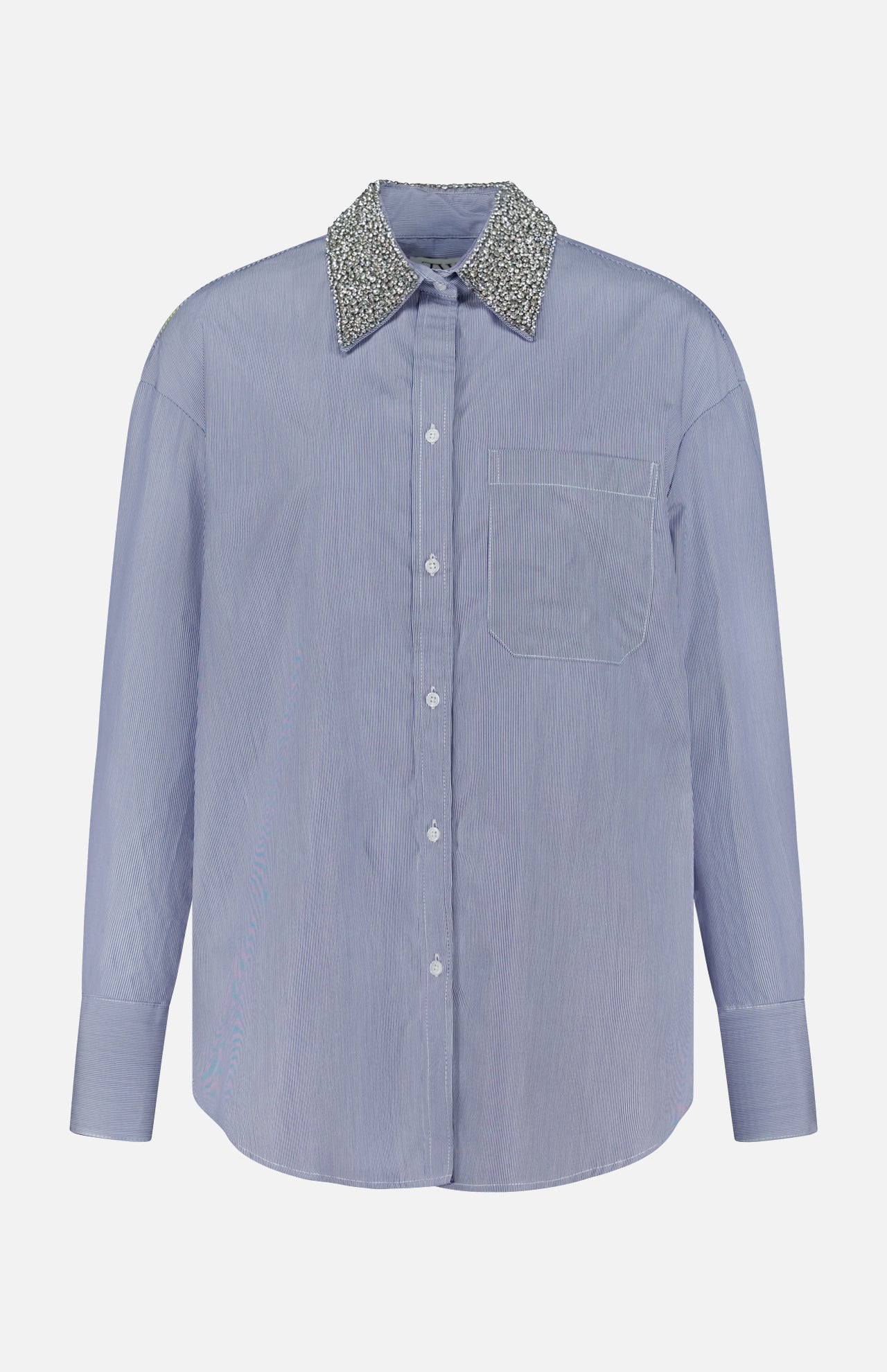 The TWP Big Joe with Crystal Collar Shirt is a light blue women’s long-sleeve button-up workwear shirt featuring a single chest pocket and a sparkly, textured silver crystal collar, shown against a plain white background.