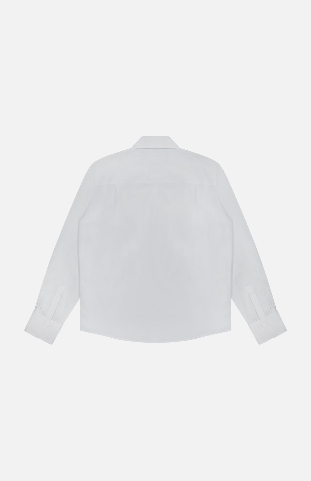 The Cowboy Update Relaxed Fit Shirt by TWP is shown from the back, featuring a crisp collar and buttoned cuffs against a white background—an essential women's workwear staple.