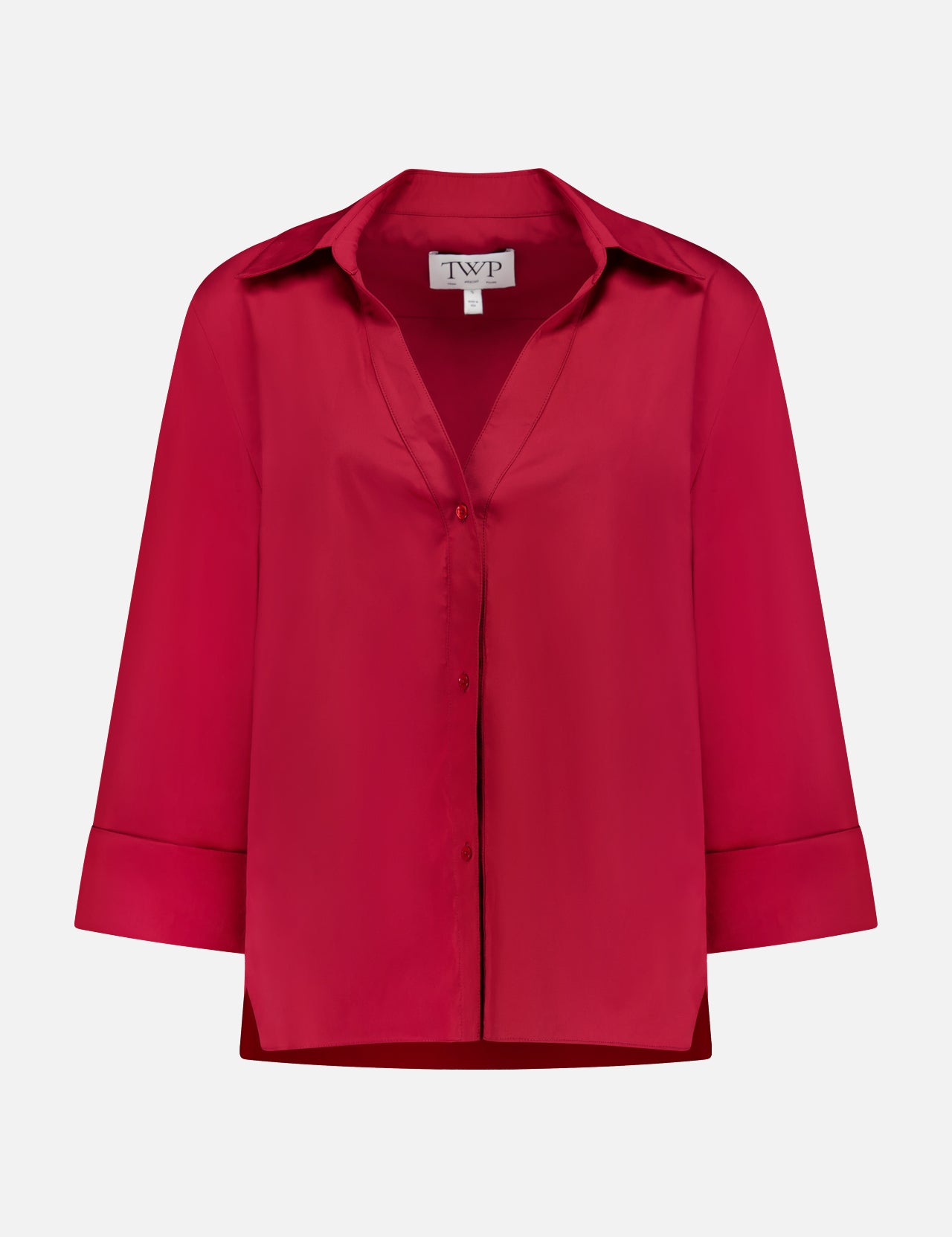 The Deep V Relaxed Shirt by TWP is a red, long-sleeve, button-up shirt with a collar and folded cuffs, made from Italian superfine cotton. Shown on a white background, the label inside reads TWP.