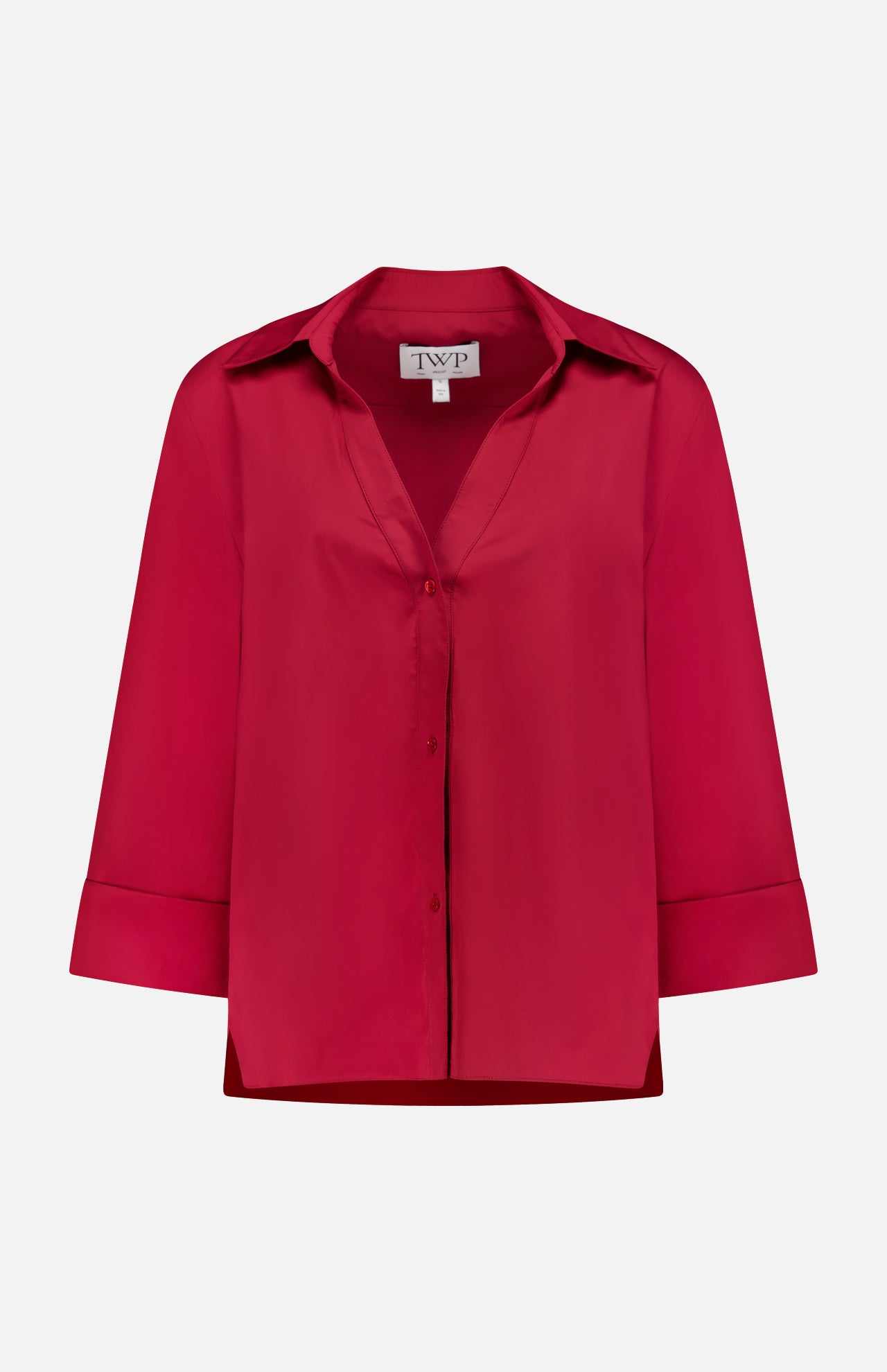 The Deep V Relaxed Shirt by TWP is a red, long-sleeve, button-up shirt with a collar and folded cuffs, made from Italian superfine cotton. Shown on a white background, the label inside reads TWP.