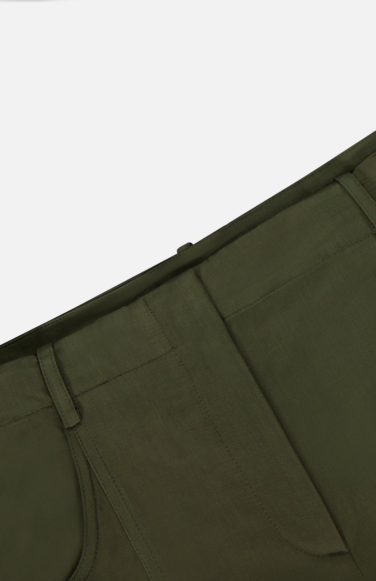 Close-up of the TWP Demie Wide Leg Trouser Pant in dark green, highlighting the waistband, belt loops, and a portion of the front pocket against a plain background. Made from a soft viscose linen blend, these wide-leg trousers combine comfort with workwear-inspired style.