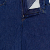 A close-up of the Dillon Denim Jeans in Dark Stone by TWP shows the open fly, zipper, inner fabric lining, front pocket, and visible stitching for a stylish women’s workwear look.