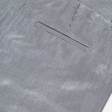 Close-up of the back pocket and waistband of TWP's Dillon Glossy Stripe Pants, featuring thin vertical light blue and white stripes and a neatly sewn pocket—an elevated, modern twist on classic women's workwear.