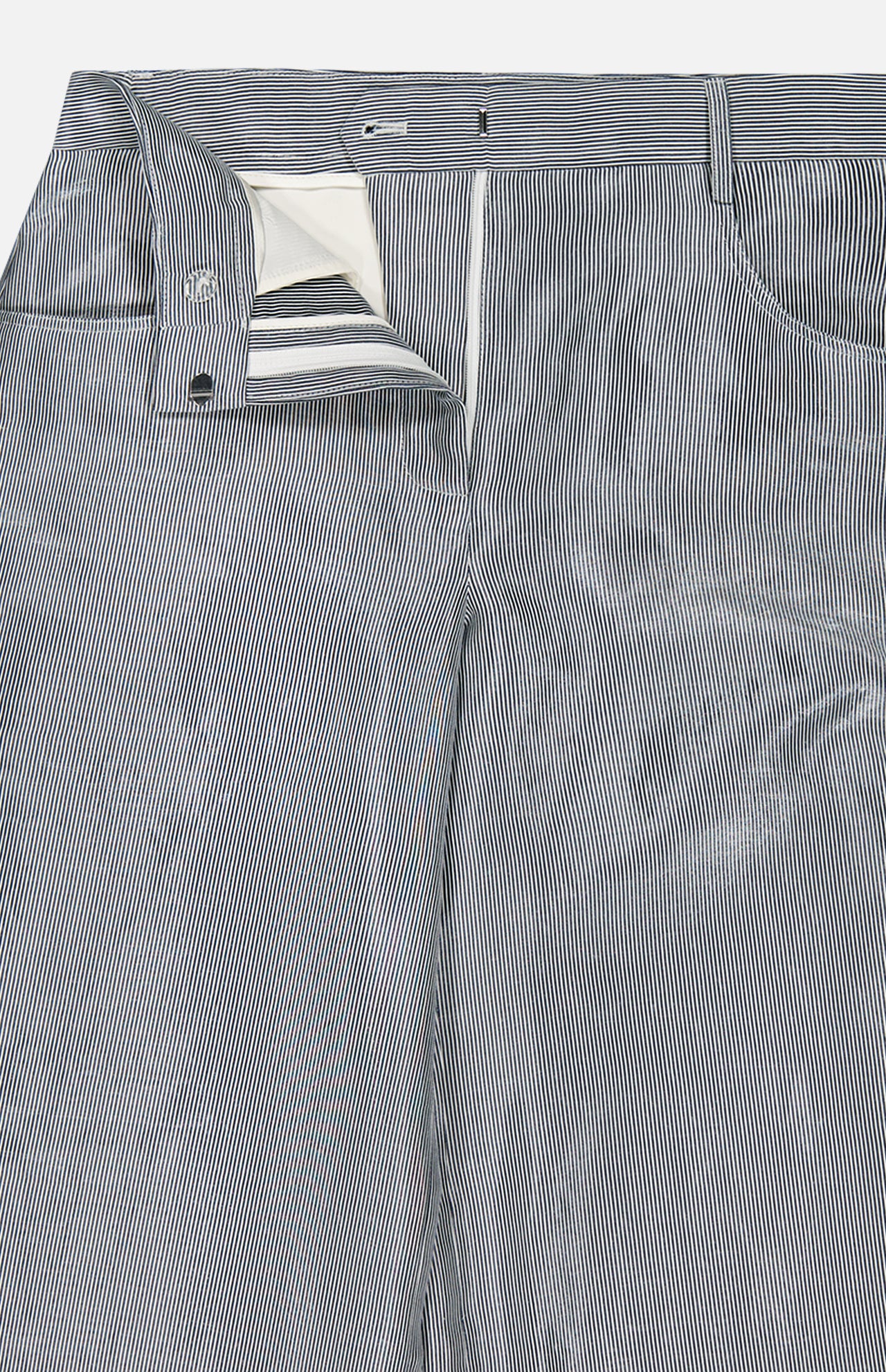 Close-up of TWP Dillon Glossy Stripe Pants—a high-rise, wide-leg style with blue-and-white stripes, open zipper, and visible white pocket lining—ideal and versatile workwear for women.