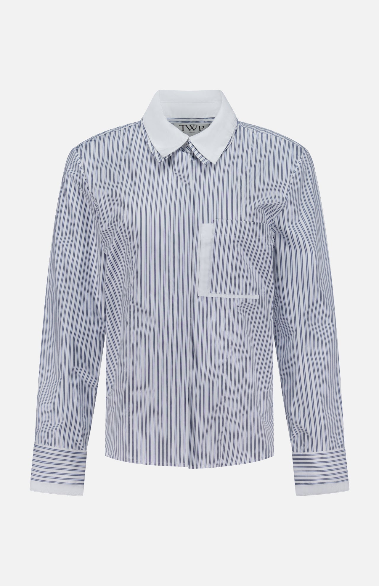 The TWP Double Layer Boyfriend Shirt is a women's long-sleeve workwear top featuring blue and white vertical stripes, a crisp white pointed collar, a chest pocket, and matching striped cuffs, displayed on a plain white background.