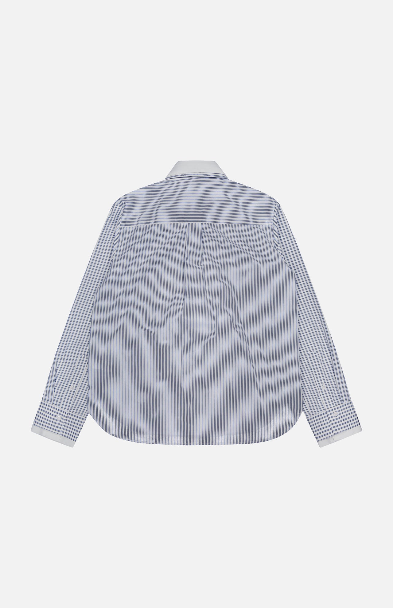 The Double Layer Boyfriend Shirt by TWP is displayed from the back, showcasing its blue and white vertical stripes with a crisp white collar and cuffs that evoke the look of a classic dress shirt, set against a plain light background.