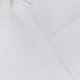A close-up of the TWP Double Layer Boyfriend Shirt—a crisp white dress shirt for women, showcasing a pointed double collar, front pocket, and a neck label with black text—an essential workwear staple.